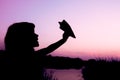 Happy child holding flightnumber silhouette on nature in the park sunset