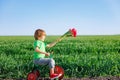 Happy child holding flowers against blue sky background Royalty Free Stock Photo