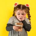 Happy child holding money, children`s joy in a lot of money, portrait of a girl on a yellow background Royalty Free Stock Photo