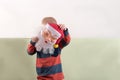 A happy child is holding a Santa Claus mask and an empty banner. Greeting card with Christmas. The concept of Christmas holidays Royalty Free Stock Photo