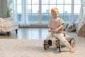 Happy child at home. Little toddler boy driving big vintage toy car and having fun. Smiling kid playing at home. Baby Royalty Free Stock Photo