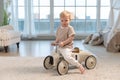 Happy child at home. Little toddler boy driving big vintage toy car and having fun. Smiling kid playing at home. Baby Royalty Free Stock Photo