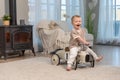 Happy child at home. Little toddler boy driving big vintage toy car and having fun. Smiling kid playing at home. Baby Royalty Free Stock Photo