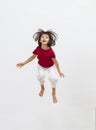 Happy child jumping with energy to express cheerful dynamism, 