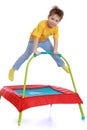 Happy child jumping on a trampoline Royalty Free Stock Photo