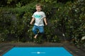 Happy child jumping on the trampoline smiling Royalty Free Stock Photo