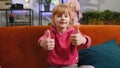 Happy child kid girl looking approvingly at camera showing thumbs up, like positive sign, good news Royalty Free Stock Photo