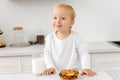 A happy child in the kitchen. The boy smiles and looks into the camera at breakfast in the kitchen Royalty Free Stock Photo