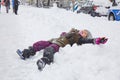 Happy child laughing lying in the snow in the city Royalty Free Stock Photo