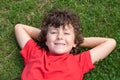 Happy child lied down on the grass Royalty Free Stock Photo