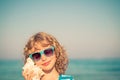 Happy child listen seashell on the beach Royalty Free Stock Photo