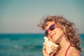 Happy child listen seashell on the beach Royalty Free Stock Photo