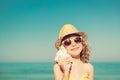 Happy child listen seashell on the beach Royalty Free Stock Photo