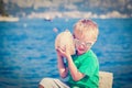 Happy child listening seashell at the beach Royalty Free Stock Photo