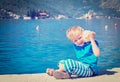 Happy child listening seashell at the beach Royalty Free Stock Photo