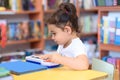 Happy child little girl pianist plays on a toy piano. Royalty Free Stock Photo