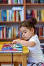 Happy child little girl reading a book. Royalty Free Stock Photo