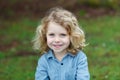 Happy child with long blond hair enjoying the nature