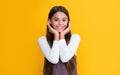 happy child with long hair on yellow background. cheerfulness