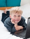 Happy child looking at his laptop Royalty Free Stock Photo