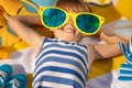 Happy child lying on beach towel