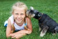 Happy child lying on the grass with her dog in the park. The Sec Royalty Free Stock Photo