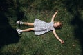 Happy child lying on the green grass in the park. Top view Royalty Free Stock Photo