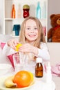 Happy child making lemon juice