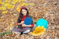 happy child with maple leaf bunch and backpack outdoor. autumn nature. childhood happiness. Royalty Free Stock Photo