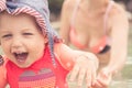 Happy child with mother having fun on the beach. Laughing child running away from mother Royalty Free Stock Photo