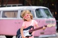 Happy child musician guitarist playing electric guitar.