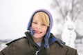 Happy Child Outside playing in the Snow after Building Snowman Royalty Free Stock Photo