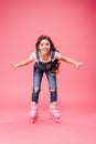 Happy child in overalls rollerblading Royalty Free Stock Photo
