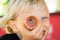 Happy child peeking through ice cream cone Royalty Free Stock Photo