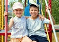 Happy child on playground outdoor, play in city park, summer season, bright sunlight Royalty Free Stock Photo