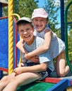 Happy child on playground outdoor, play in city park, summer season, bright sunlight Royalty Free Stock Photo