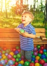 Happy child playing with colorful plastic balls Royalty Free Stock Photo