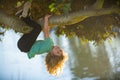 Happy child playing in the garden climbing on the tree. Upside down. Childhood concept. Royalty Free Stock Photo