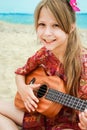 Happy child playing guitar by the sea greece on nature background Royalty Free Stock Photo