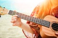 Happy child playing guitar by the sea greece on nature background Royalty Free Stock Photo