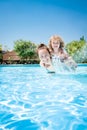 Happy child playing with mother in pool Royalty Free Stock Photo