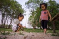 Happy child playing with sand, Funny Asian family in a park