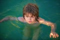 Happy child playing in the sea. Kid boy having fun on the beach. Summer vacation and healthy kids lifestyle concept. Royalty Free Stock Photo