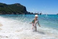 Happy child playing in the sea. Kid having fun at the beach. Royalty Free Stock Photo