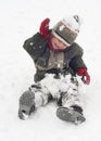 Happy child playing with snow in winter