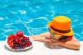 Happy child playing in swimming pool. Summer kids vacation. Summer fruit for children. Little kid boy relaxing in a pool Royalty Free Stock Photo