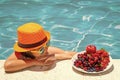 Happy child playing in swimming pool. Summer kids vacation. Summer fruit for children. Little kid boy relaxing in a pool Royalty Free Stock Photo