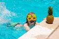 Happy child playing in swimming pool. Summer kids vacation. Little kid boy relaxing in a pool having fun during summer Royalty Free Stock Photo