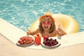 Happy child playing in swimming pool. Summer kids vacation. Summer fruit for children. Little kid boy relaxing in a pool Royalty Free Stock Photo