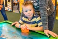 Happy child playing table air hockey Royalty Free Stock Photo